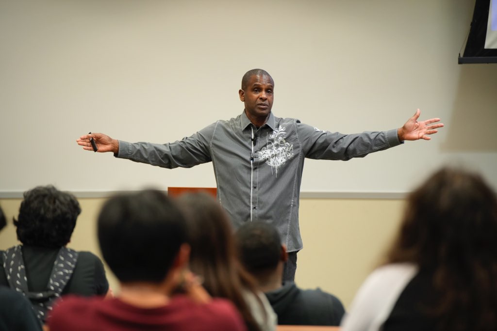 Darryl teaching with his arms open